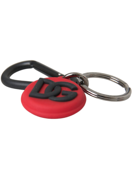 a red and black keychain with a logo on it