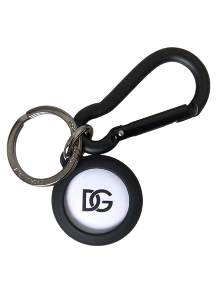 a black and white keychain with a logo on it