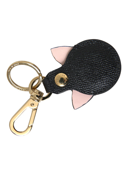 a black leather keychain with a pink and black shark design