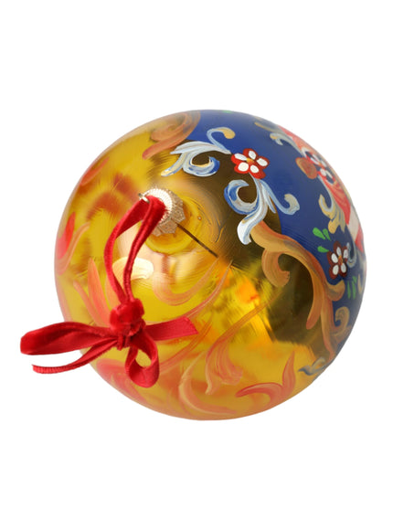 a glass ornament with a red ribbon around it