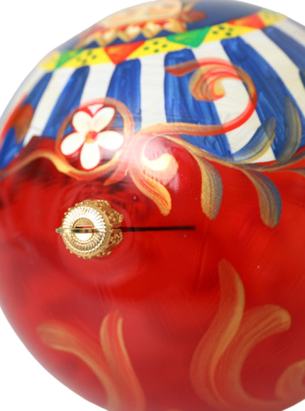 a close up of a red ball with a gold handle