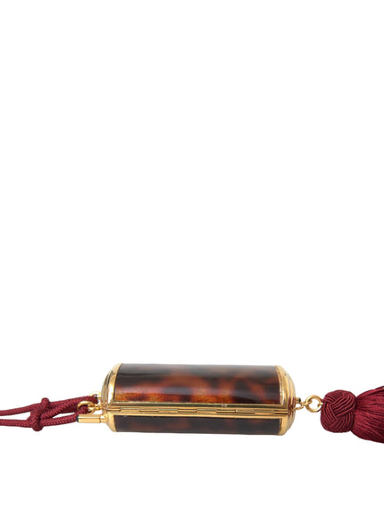 a tasseled tortoise shell pendant with a tassel