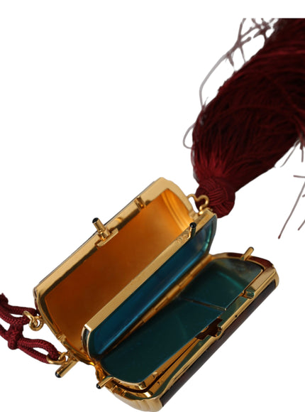 an open suitcase with a tassel hanging from it