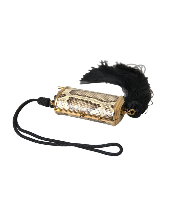 a gold case with a black feather on it