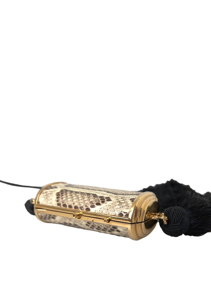 a gold lighter with a black cord on a white background