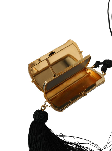 a gold purse with a tassel hanging from it