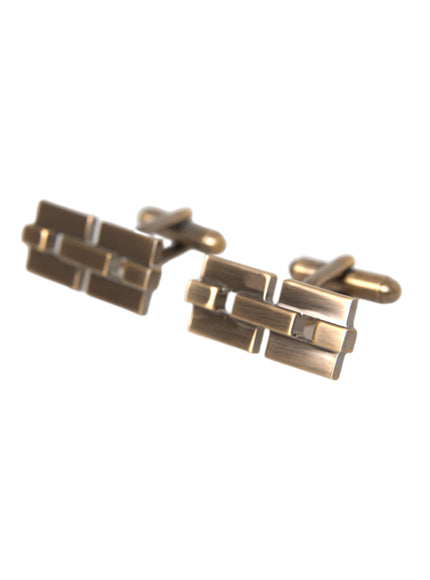 a pair of gold cufflinks on a white background