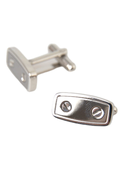 a pair of silver cufflinks on a white background