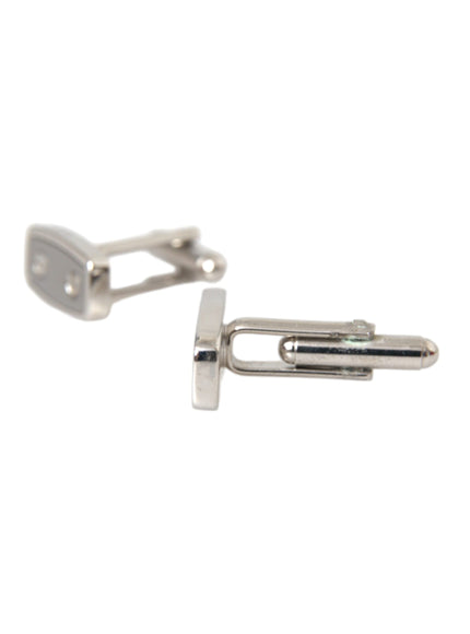 a pair of silver cufflinks on a white background