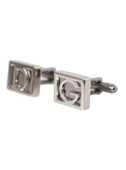 a pair of silver cufflinks with the letter g on them