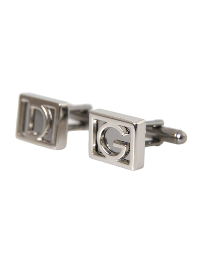 a pair of silver cufflinks with the letter g on them