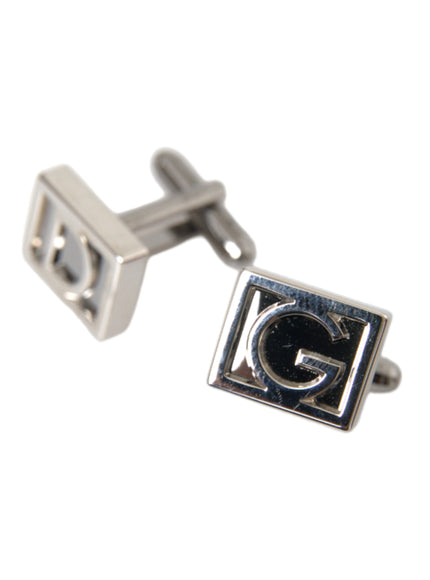 a pair of cufflinks with the letter g on them