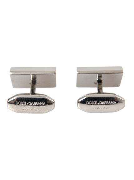 a pair of silver cufflinks on a white background