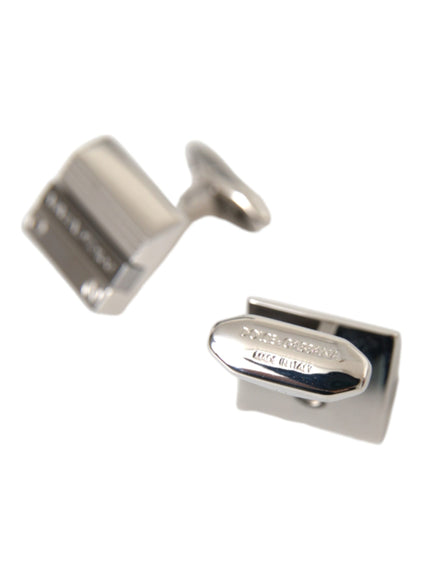 a pair of silver cufflinks on a white background