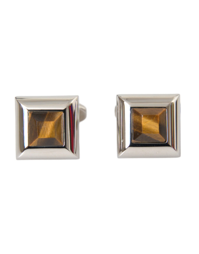 a pair of cufflinks with a square shaped stone