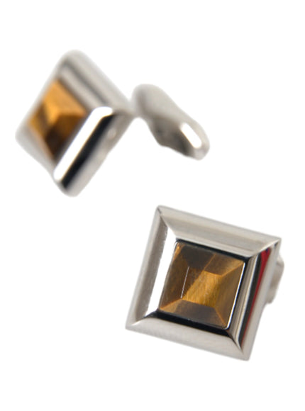 a pair of cufflinks with a square shaped stone