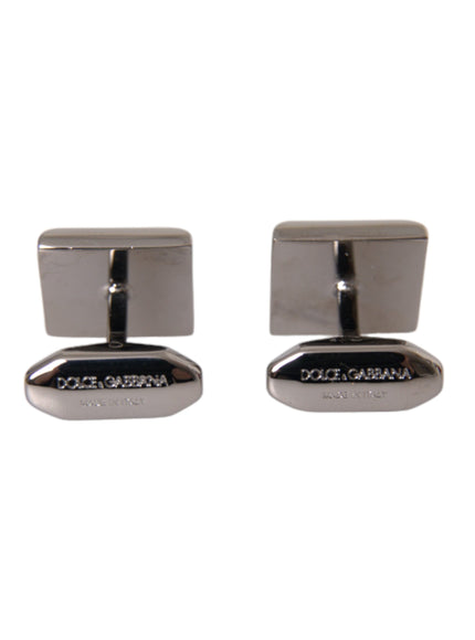 a pair of silver cufflinks on a white background