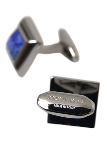 a pair of cufflinks with a blue stone in the middle