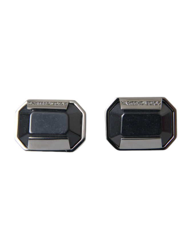 a pair of black and silver cufflinks on a white background