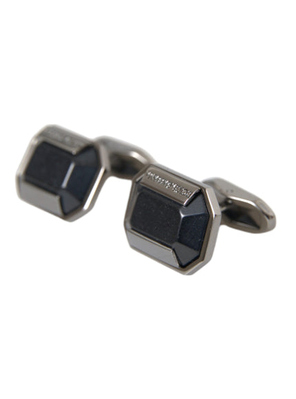 a pair of black and silver cufflinks on a white background