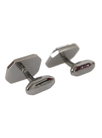 a pair of silver cufflinks on a white background