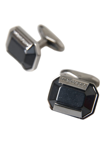 a pair of black and silver cufflinks on a white background