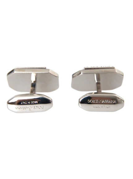 a pair of silver cufflinks on a white background