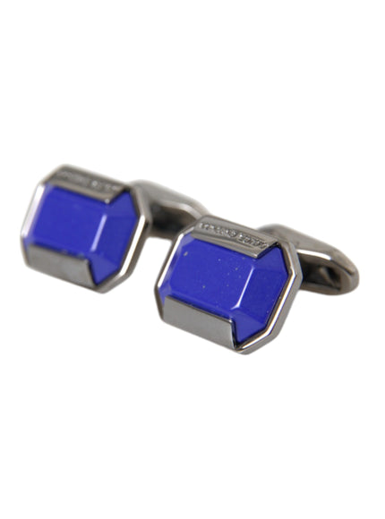 a pair of blue cufflinks on a white background