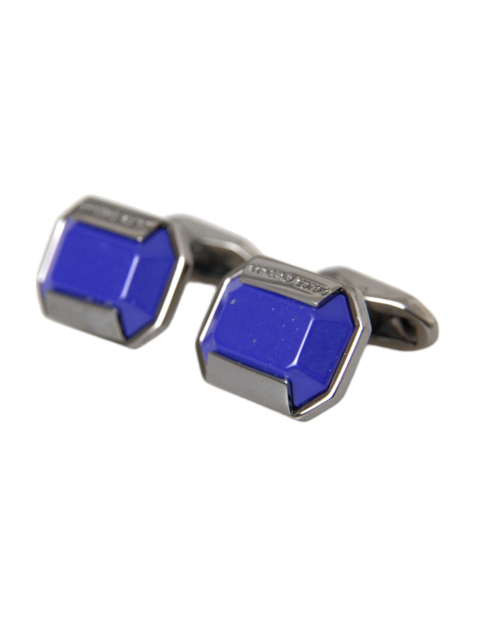 a pair of blue cufflinks on a white background