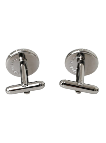 a pair of silver cufflinks on a white background