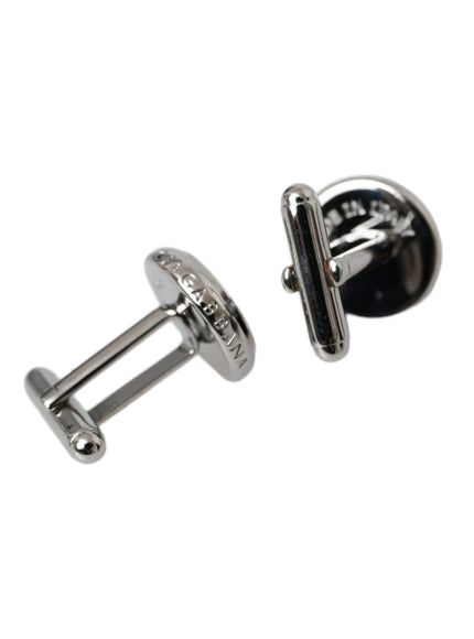 a pair of black and silver cufflinks