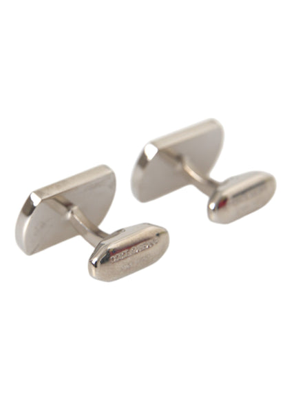 a pair of silver cufflinks on a white background