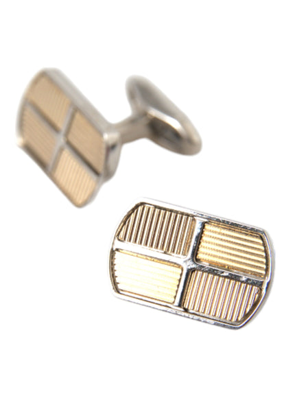 a pair of gold cufflinks on a white background