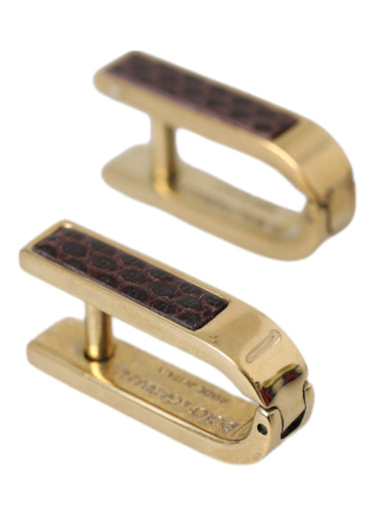 a pair of gold colored metal clips