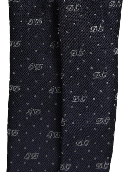 Detailed view of DG logo pattern on blue silk tie