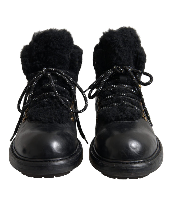 Front view of Dolce & Gabbana black leather shearling boots