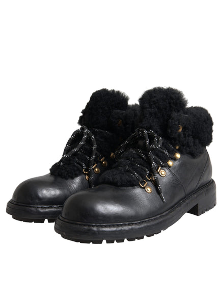 Angled view of Dolce & Gabbana black leather shearling boots