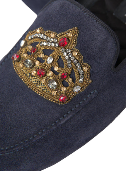 Close-up of crown embroidery on blue leather loafers