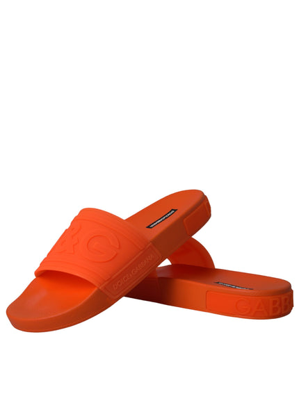 Pair of Dolce & Gabbana orange rubber slides stacked