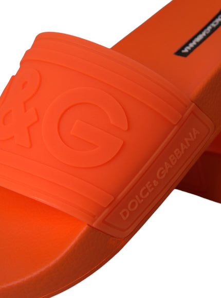 Close-up of Dolce & Gabbana logo on orange rubber slides