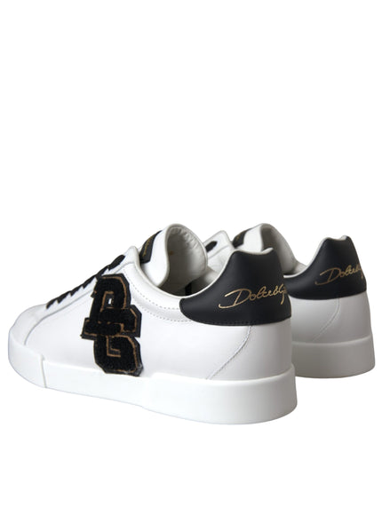 a pair of white sneakers with black and gold lettering