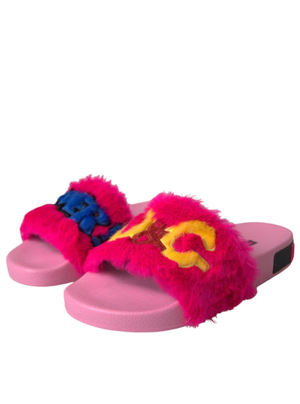 a pair of pink slippers with a yellow and blue logo