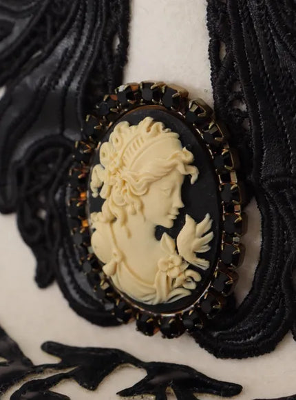 Close-up of cameo brooch on Dolce & Gabbana hat