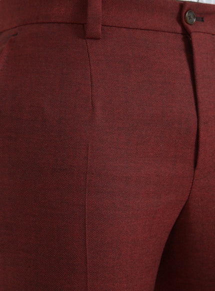 Close-up of maroon wool fabric on dress pants