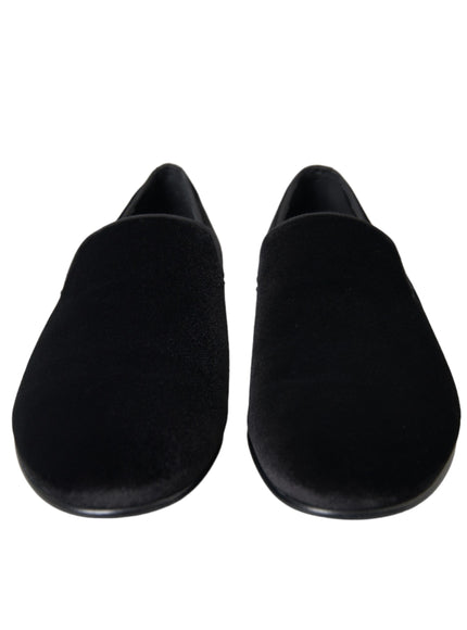 a pair of black slippers on a white background