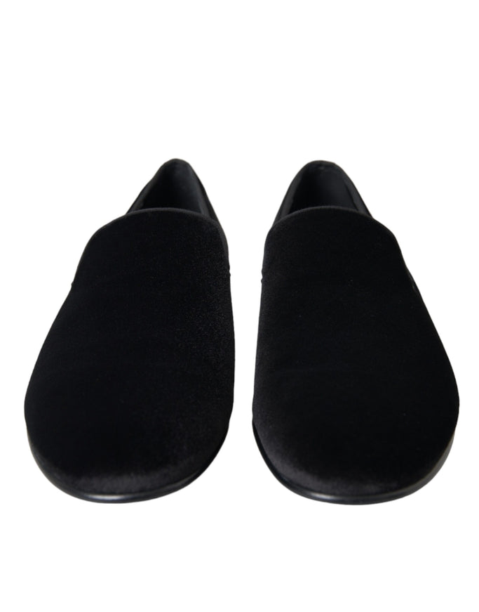 a pair of black slippers on a white background