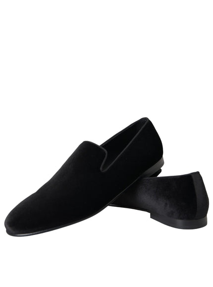 a pair of black slippers on a white background