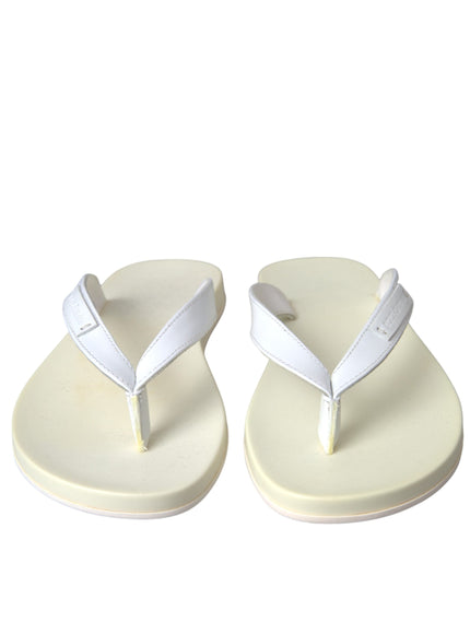 a pair of white sandals on a white background