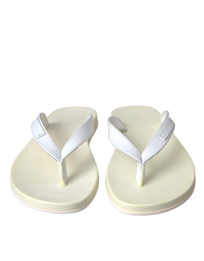 a pair of white sandals on a white background