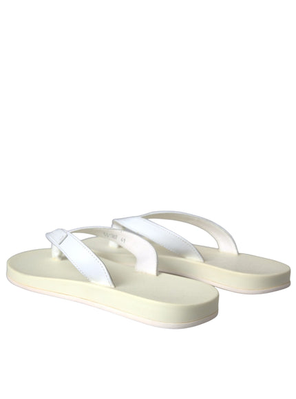 a pair of white sandals on a white background